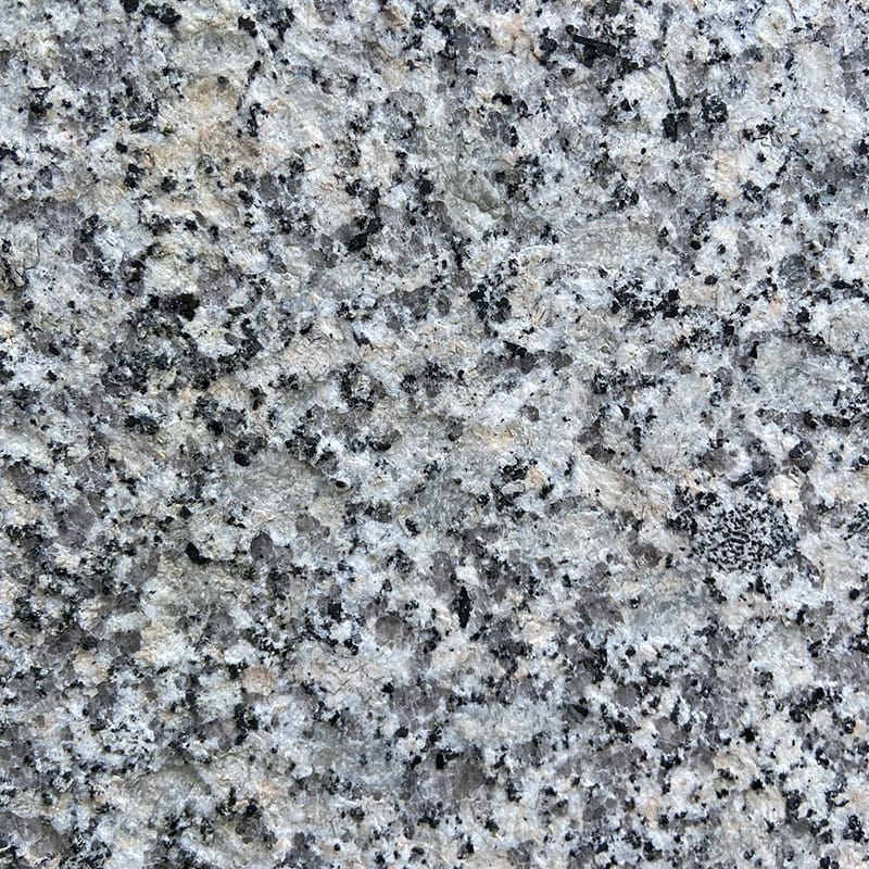 Detailed view of grey granite with contrasting black and white speckles, highlighting the stone's unique surface characteristics