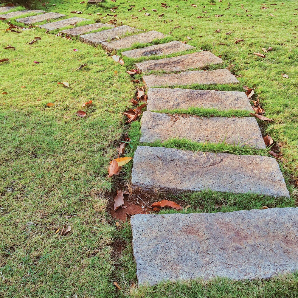 Granite wall stones used to create a natural path through a lush garden, enhancing the outdoor landscape's beauty